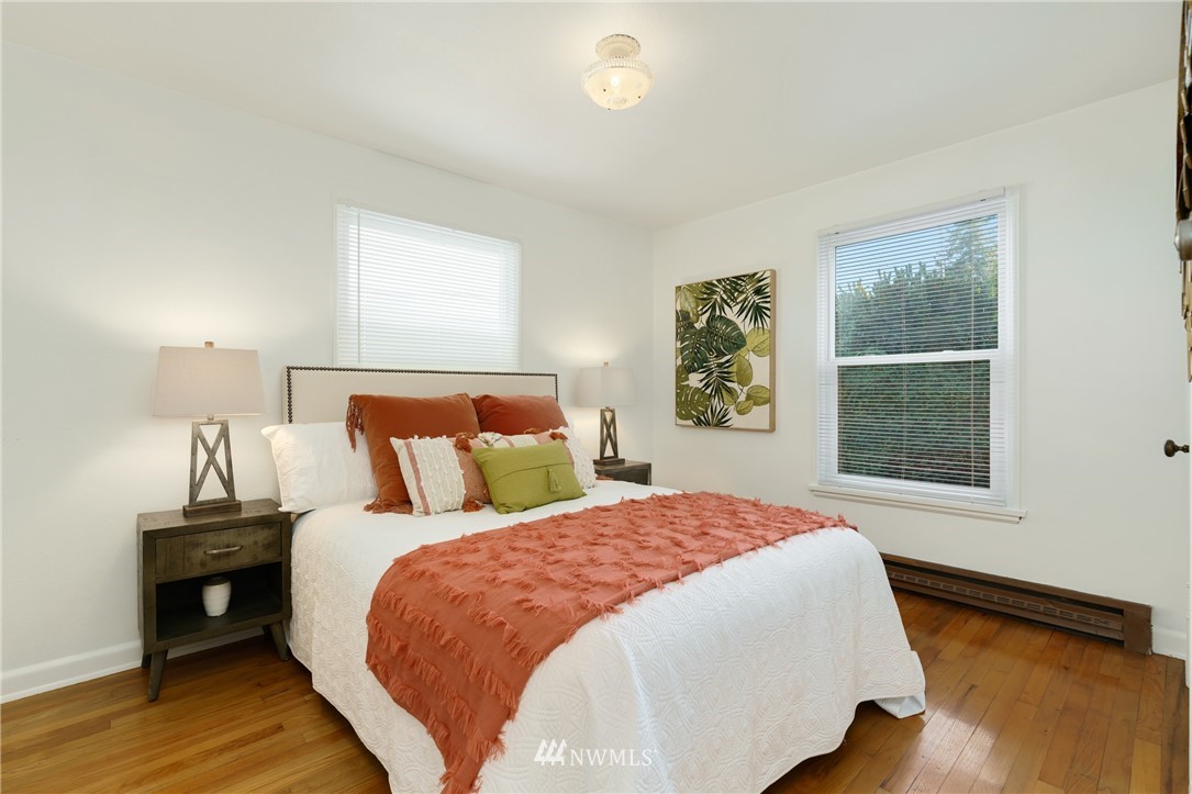 3721 37th Avenue Southwest Seattle, WA 98126 - Photo 8 of 19 a bed sitting in a bedroom next to a window