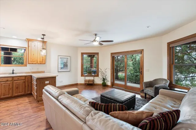 a view of a livingroom with wooden floor and furniture