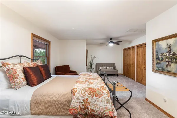 a living room with furniture kitchen view and a large window