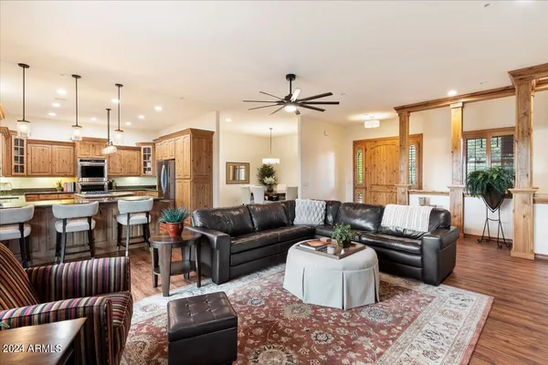 a living room with kitchen island furniture and a chandelier