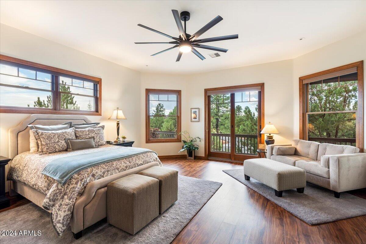 2304 East Blue Bell Circle Payson, AZ 85541 - Photo 5 of 65 a spacious bedroom with a bed couch and a large window with wooden floor