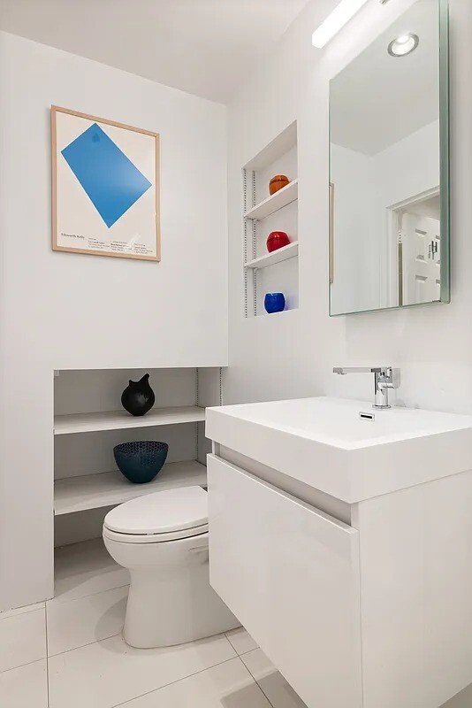 57 East 75th Street, Unit 1F Manhattan, NY 10021 - Photo 8 of 10 a bathroom with a toilet sink and mirror
