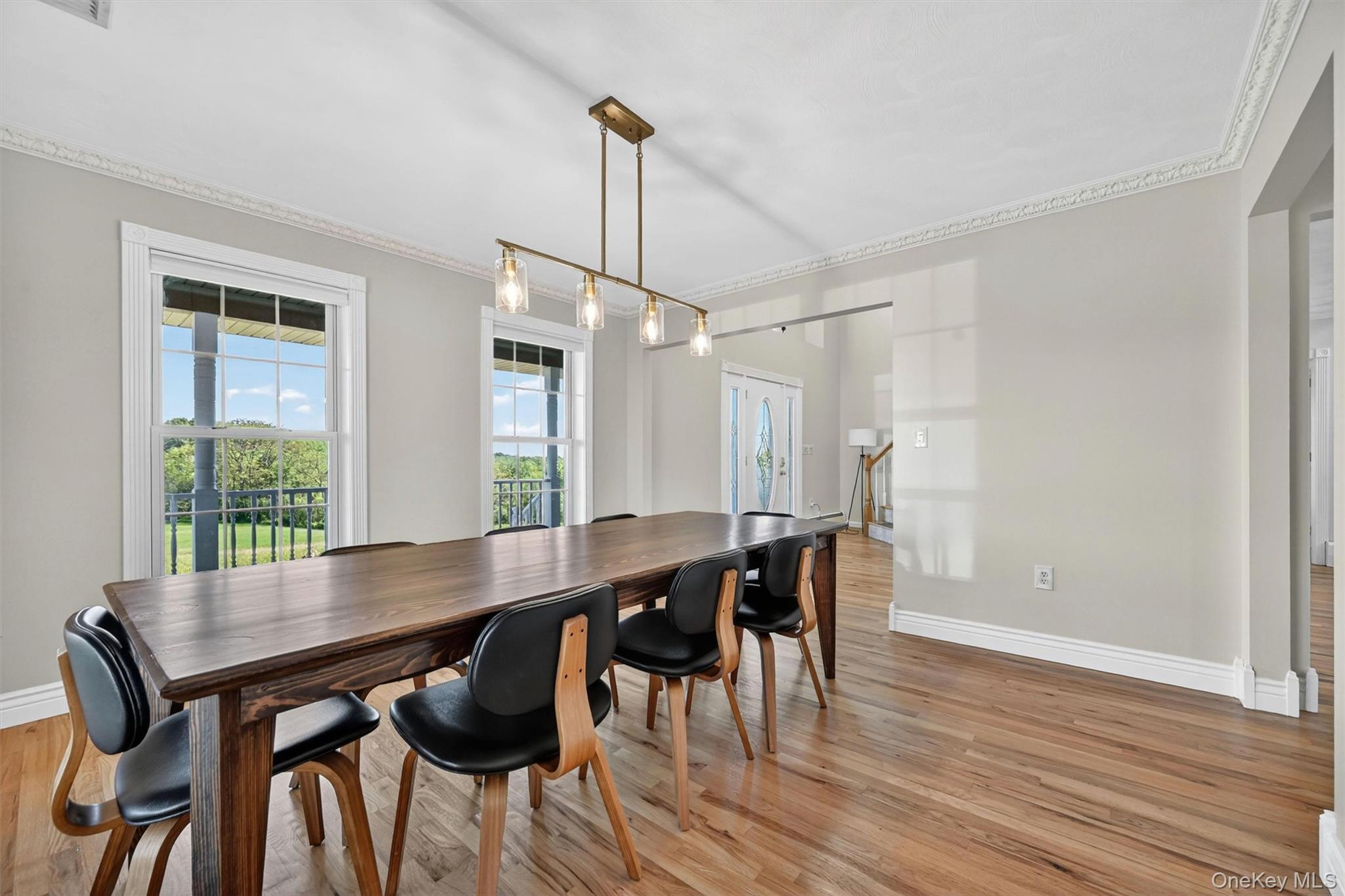 954 Ridgebury Road New Hampton, NY 10958 - Photo 23 of 45 The dining room feels warm and inviting, with beautifully refinished hardwood floors, soft natural light, and plenty of space for holidays, dinners, and long conversations around the table.