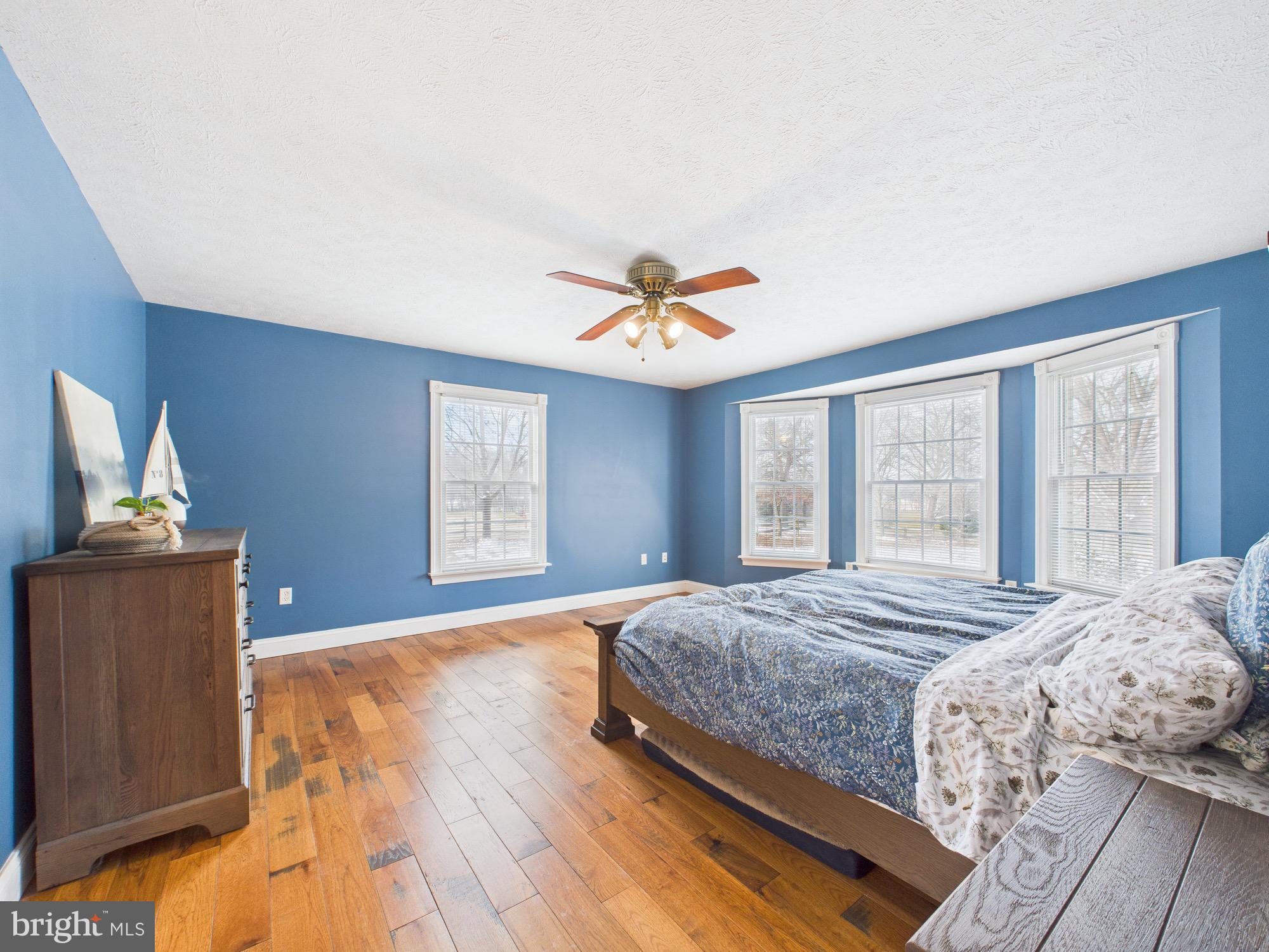 56 Smoot Road Woodstock, VA 22664 - Photo 18 of 52 a bedroom with a bed and wooden floor