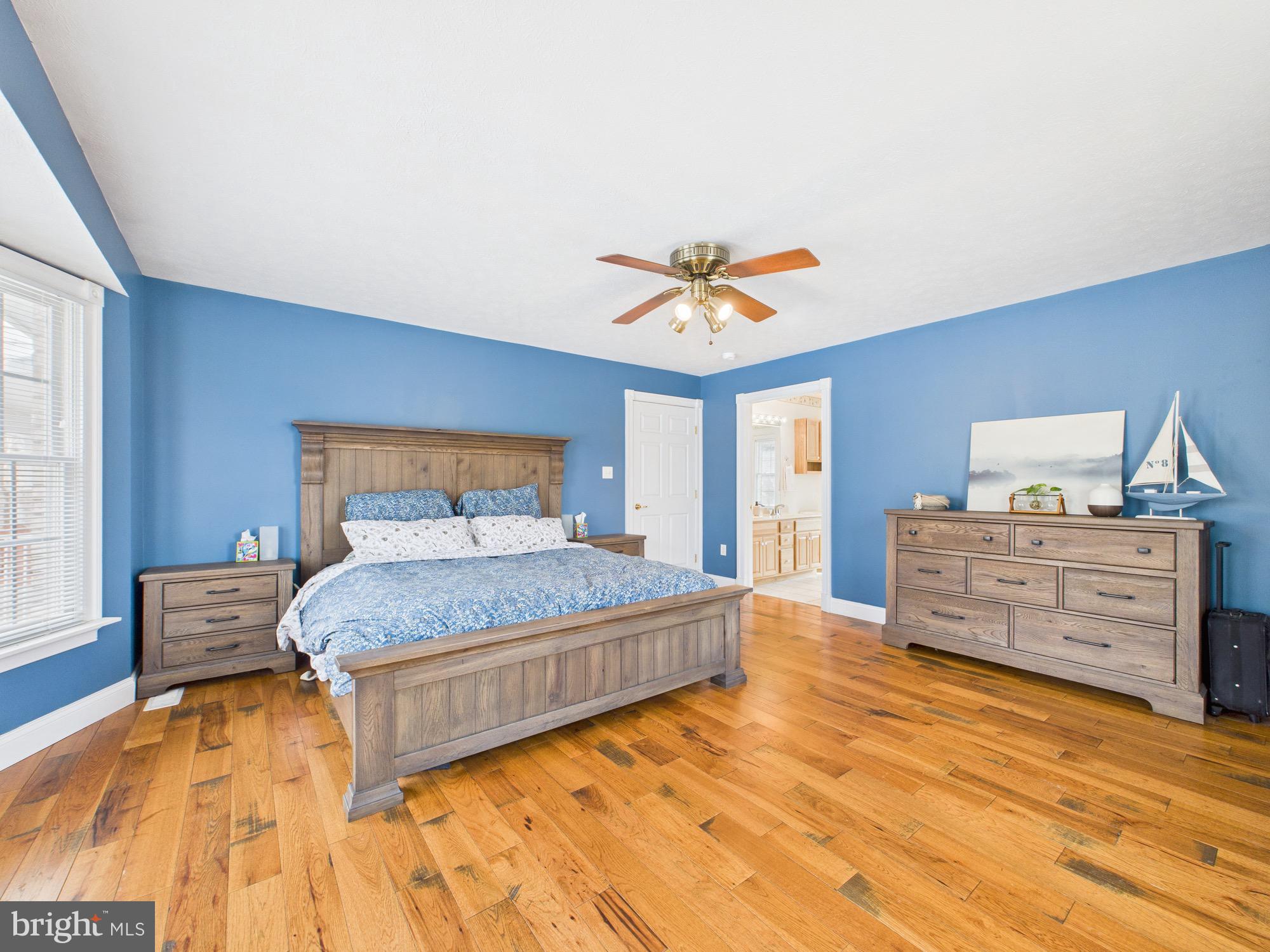 56 Smoot Road Woodstock, VA 22664 - Photo 19 of 52 a bedroom with a bed and wooden floor
