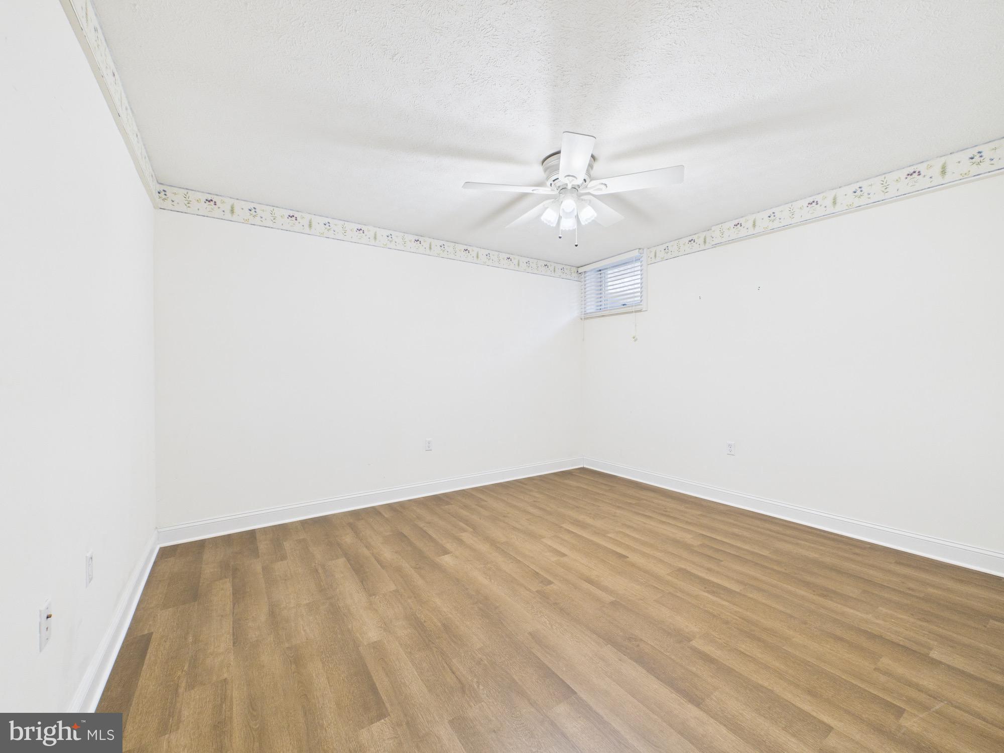 56 Smoot Road Woodstock, VA 22664 - Photo 32 of 52 an empty room with wooden floor and ceiling fan