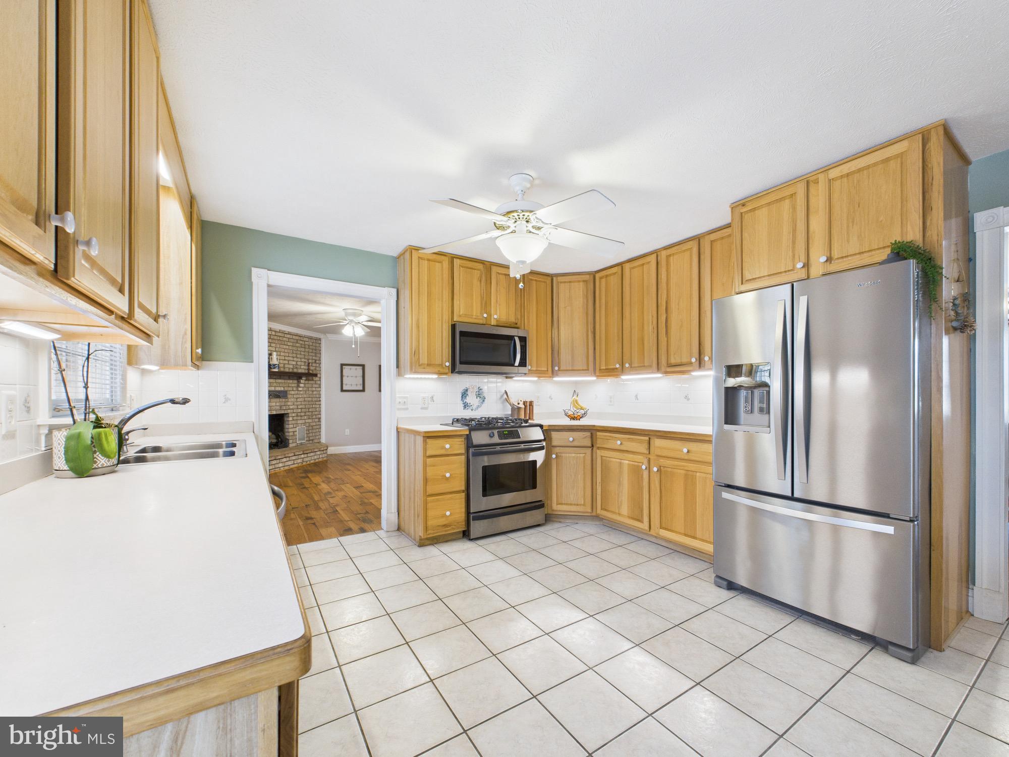 56 Smoot Road Woodstock, VA 22664 - Photo 10 of 52 a kitchen with granite countertop a refrigerator and a stove top oven