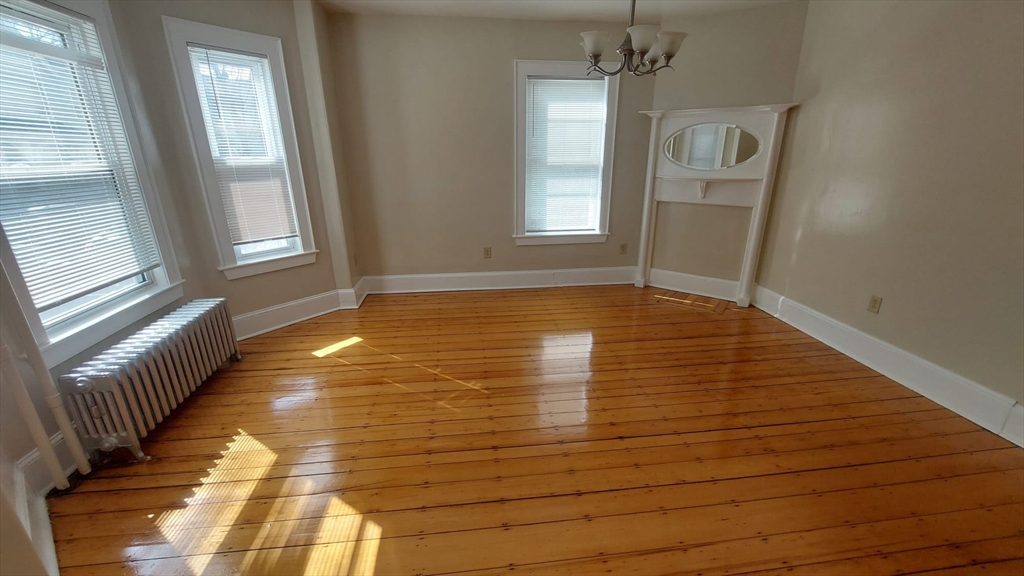 35 Catawba Street, Unit 2 Boston, MA 02119 - Photo 11 of 14 a view of empty room with wooden floor and fan