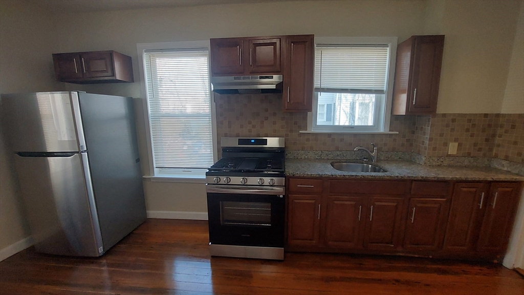 35 Catawba Street, Unit 2 Boston, MA 02119 - Photo 2 of 14 a kitchen with stainless steel appliances granite countertop a refrigerator stove and sink