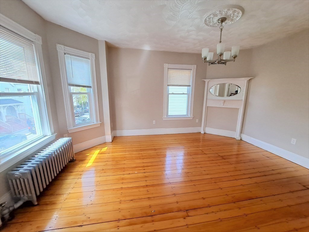 35 Catawba Street, Unit 2 Boston, MA 02119 - Photo 4 of 14 a view of an empty room with wooden floor and a window