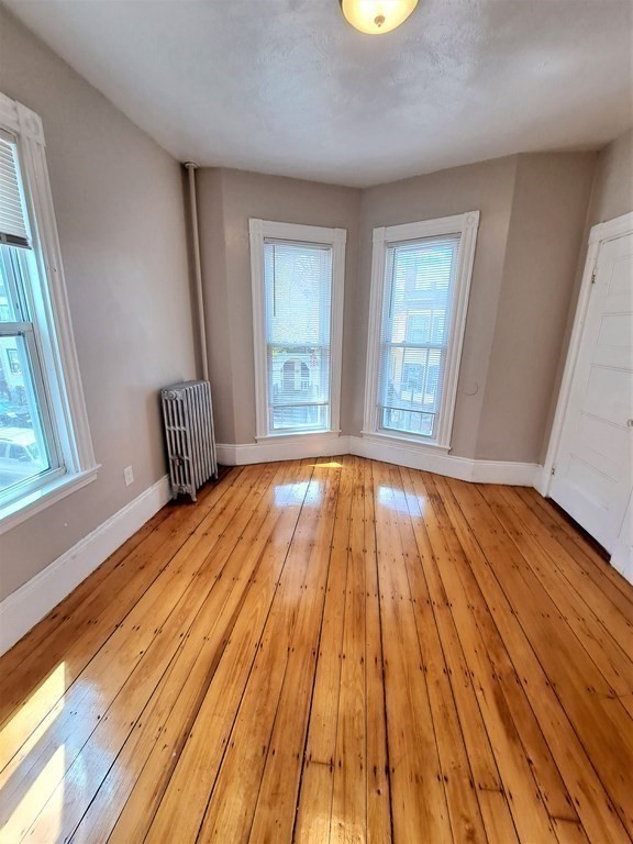 35 Catawba Street, Unit 2 Boston, MA 02119 - Photo 7 of 14 a view of wooden floor in a room with a window