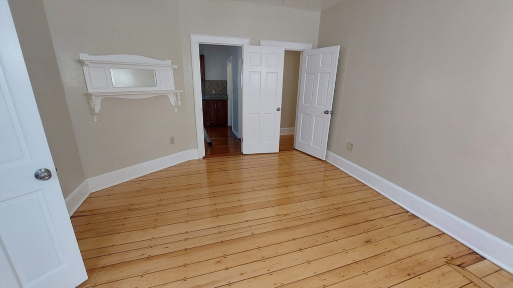 35 Catawba Street, Unit 2 Boston, MA 02119 - Photo 8 of 14 wooden floor in an empty room