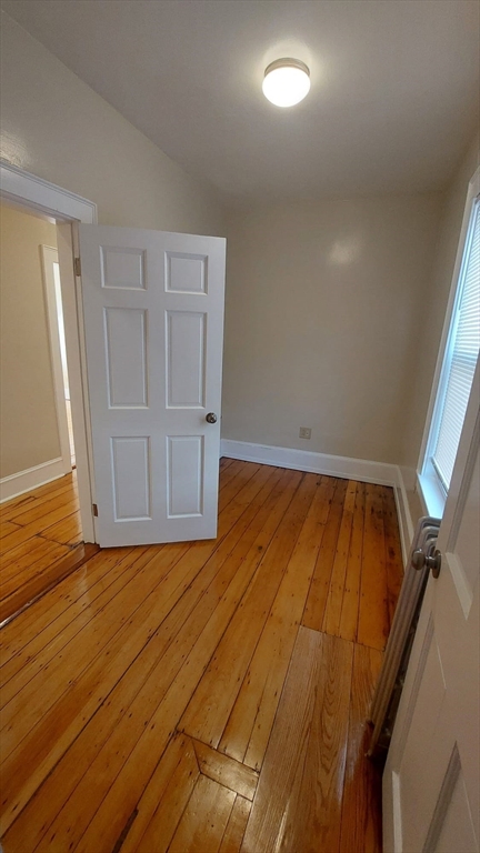 35 Catawba Street, Unit 2 Boston, MA 02119 - Photo 10 of 14 a view of an empty room with wooden floor