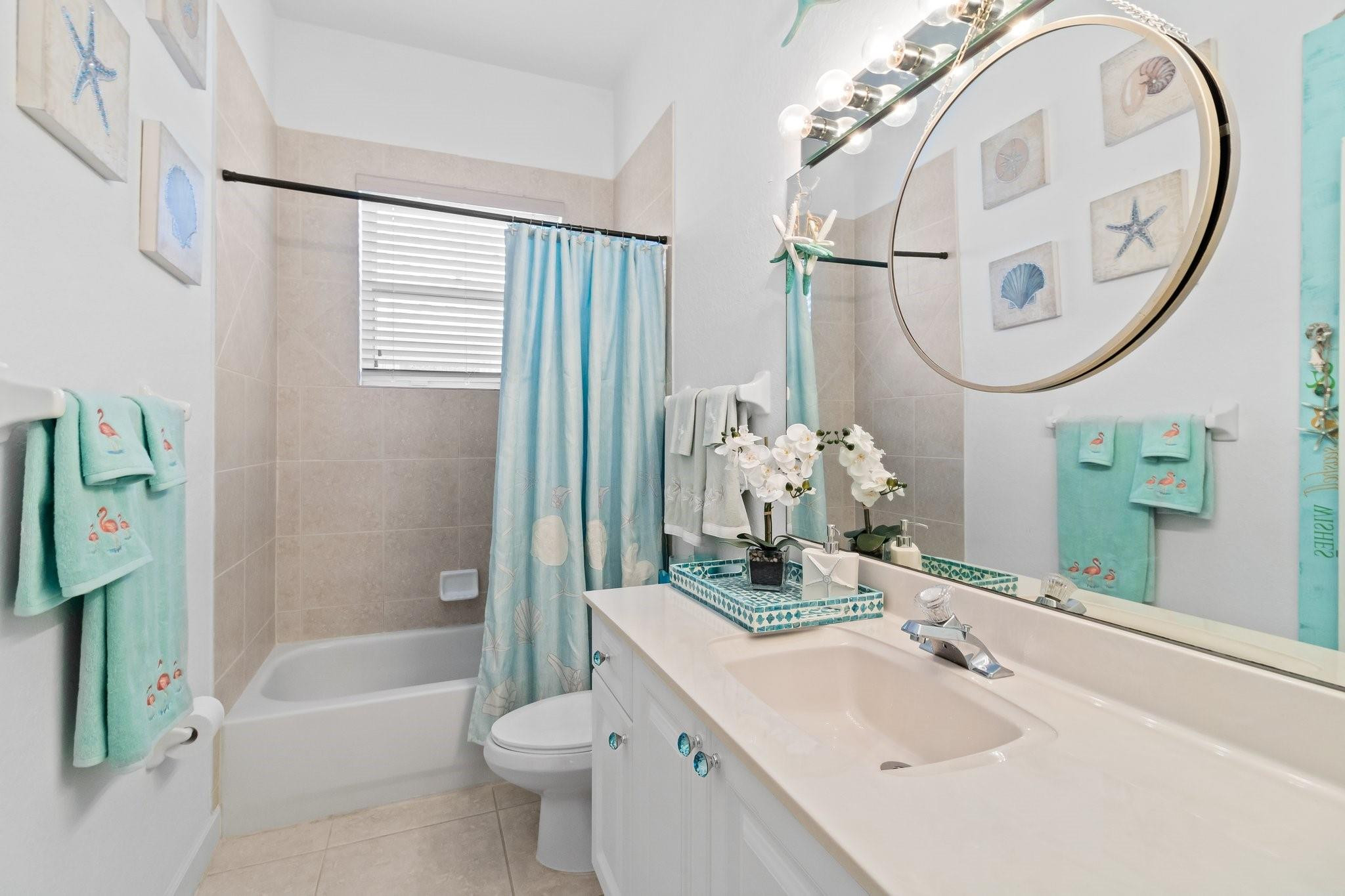 3017 Ocelot Way Fort Pierce, FL 34949 - Photo 17 of 20 a bathroom with a sink a toilet and a mirror
