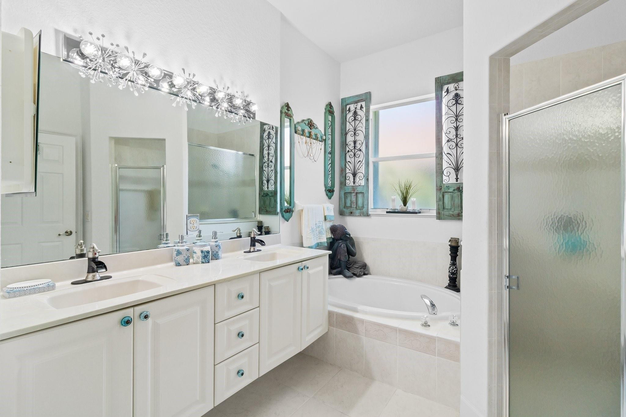 3017 Ocelot Way Fort Pierce, FL 34949 - Photo 18 of 20 a bathroom with a double vanity sink mirror double and shower