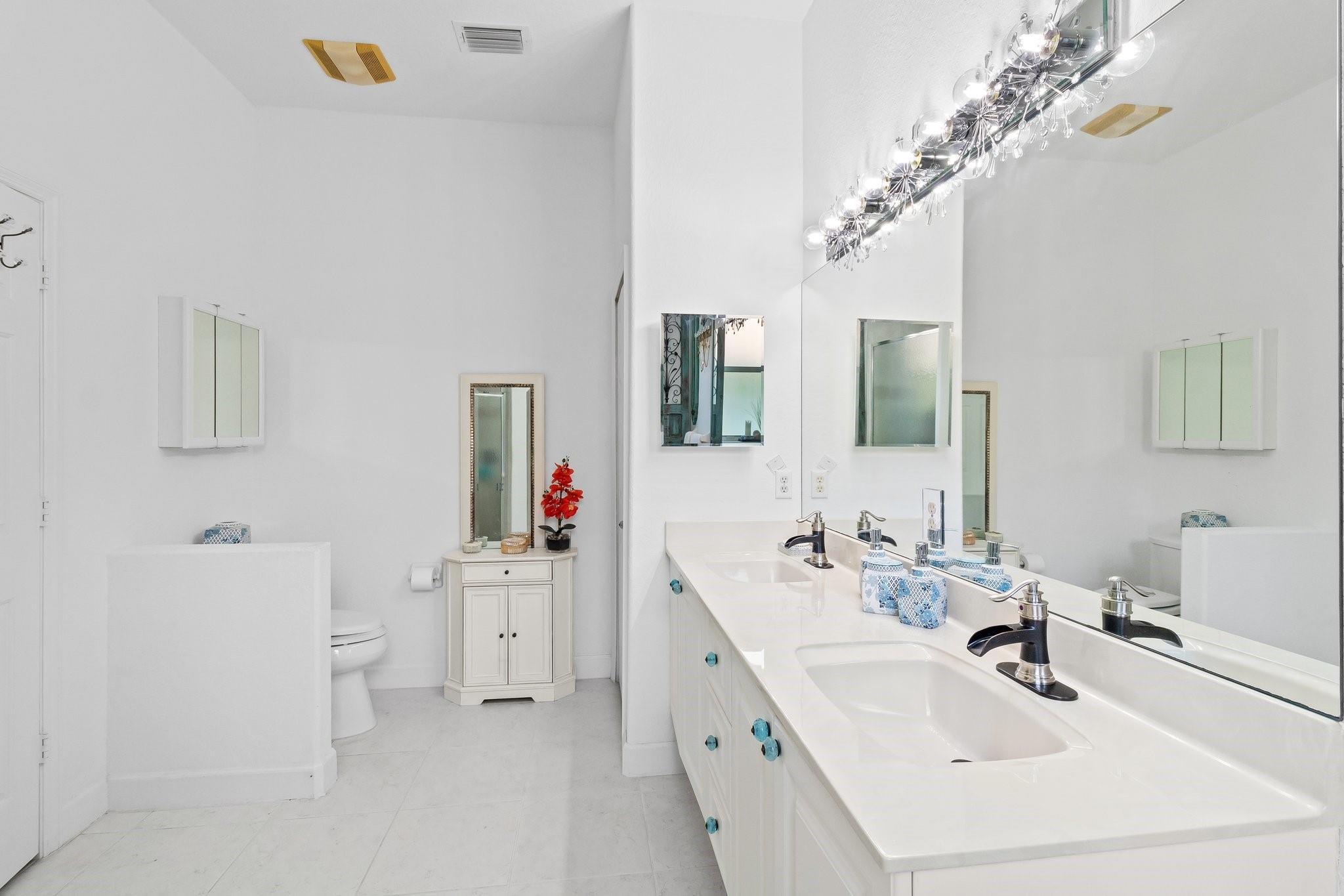 3017 Ocelot Way Fort Pierce, FL 34949 - Photo 19 of 20 a bathroom with a sink a mirror and a lamp