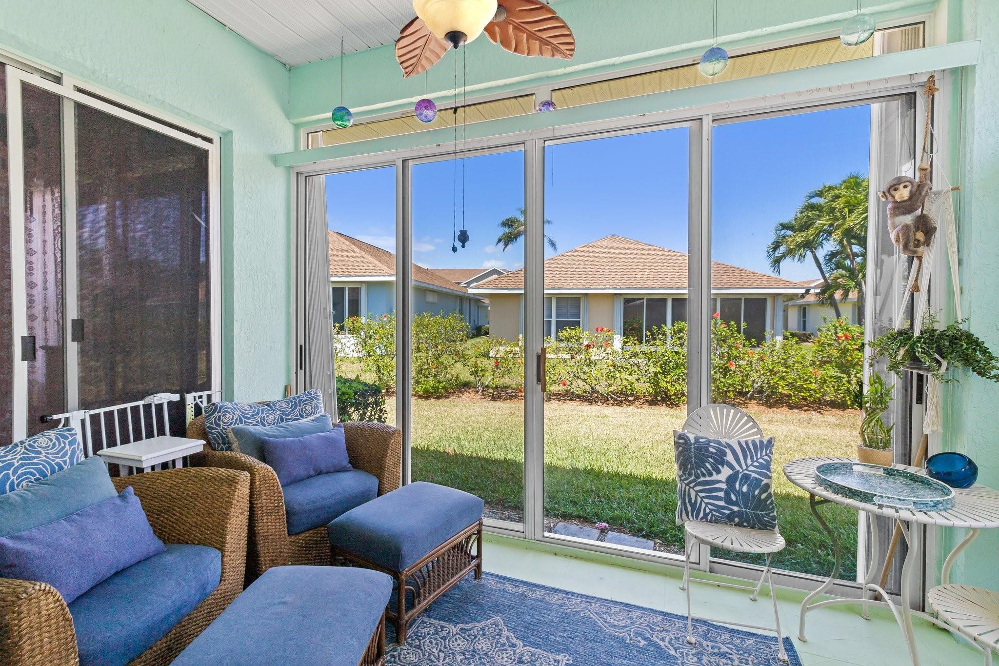 3017 Ocelot Way Fort Pierce, FL 34949 - Photo 20 of 20 a living room with furniture and a floor to ceiling window