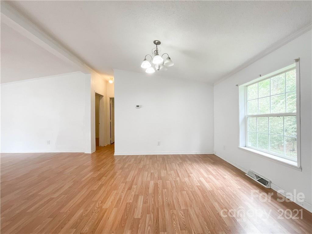 3512 Edwards Road Wingate, NC 28174 - Photo 14 of 42 a view of an empty room with wooden floor and a window