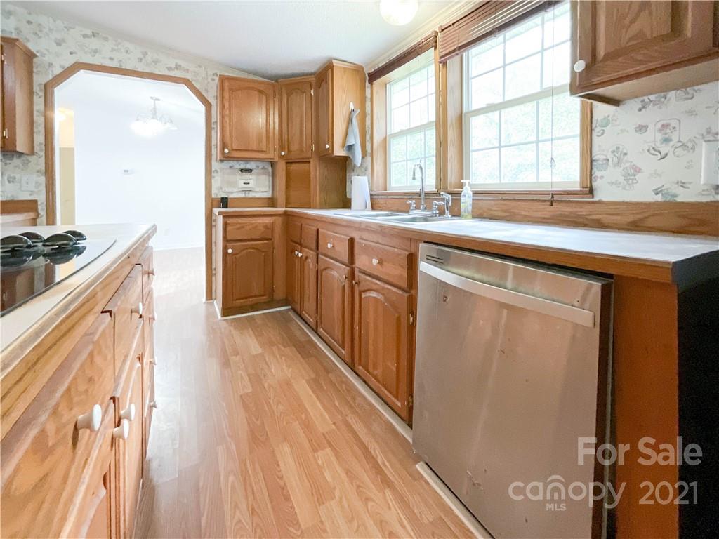 3512 Edwards Road Wingate, NC 28174 - Photo 17 of 42 a kitchen with stainless steel appliances granite countertop a sink a stove and a refrigerator