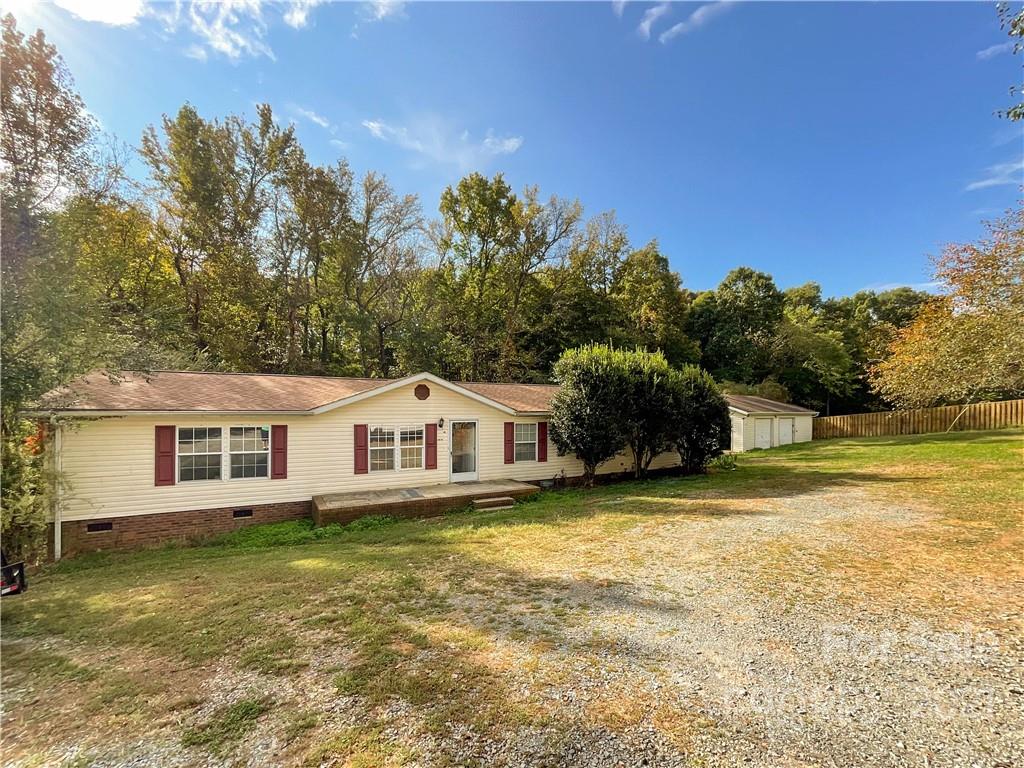 3512 Edwards Road Wingate, NC 28174 - Photo 2 of 42 a house with trees in the background