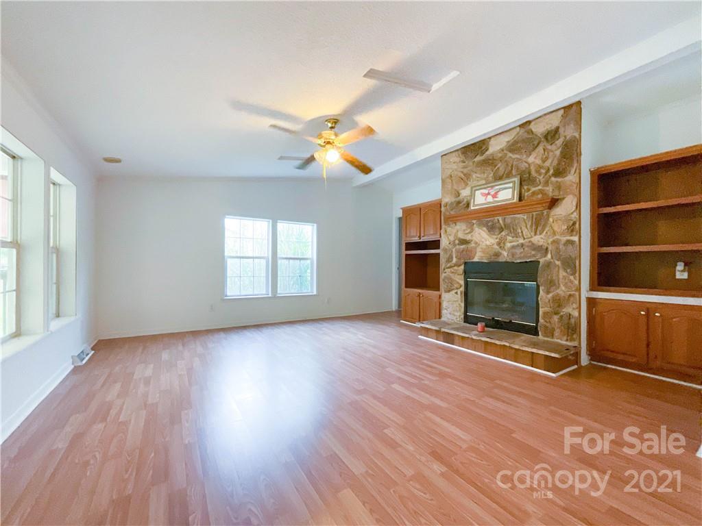 3512 Edwards Road Wingate, NC 28174 - Photo 21 of 42 wooden floor fireplace and windows in an empty room