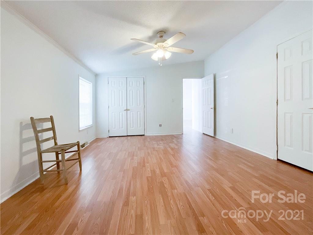 3512 Edwards Road Wingate, NC 28174 - Photo 25 of 42 a view of a livingroom with wooden floor and a ceiling fan