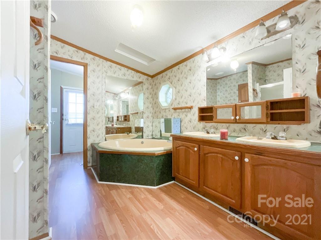 3512 Edwards Road Wingate, NC 28174 - Photo 29 of 42 a large bathroom with a large mirror and sink