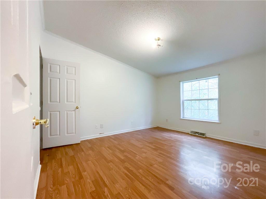 3512 Edwards Road Wingate, NC 28174 - Photo 33 of 42 an empty room with wooden floor and windows
