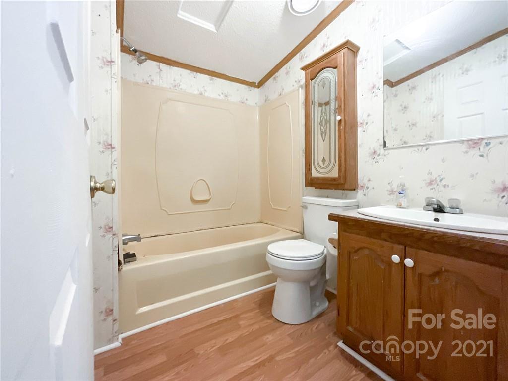 3512 Edwards Road Wingate, NC 28174 - Photo 35 of 42 a bathroom with a granite countertop sink toilet and shower