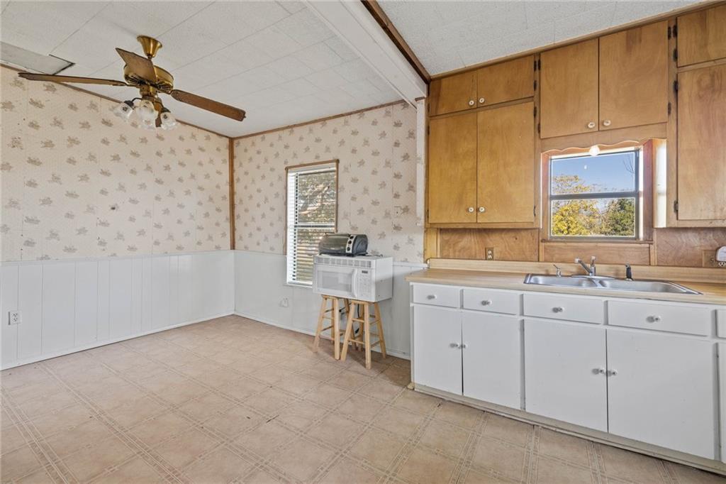 211 7th Street Jarrell, TX 76537 - Photo 11 of 26 a spacious bathroom with a sink mirror and a bathtub