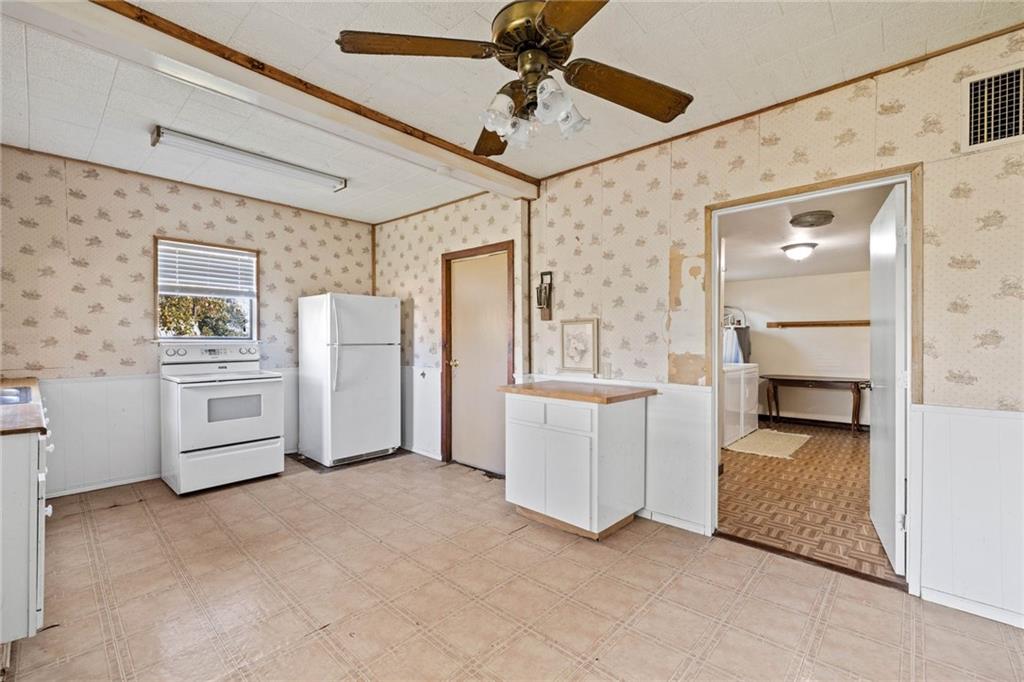 211 7th Street Jarrell, TX 76537 - Photo 12 of 26 a view of kitchen with furniture and refrigerator