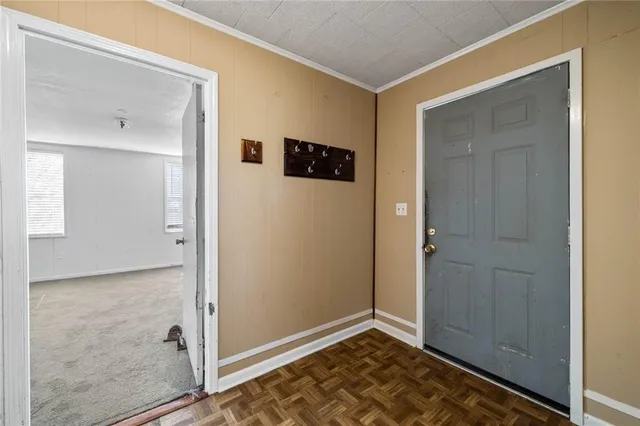 a view of empty room with wooden floor and cabinet