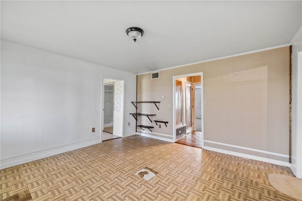 211 7th Street Jarrell, TX 76537 - Photo 14 of 26 a bedroom with a bed and wooden floor