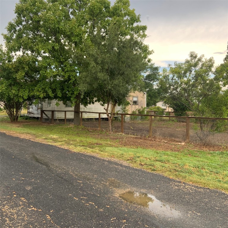 211 7th Street Jarrell, TX 76537 - Photo 5 of 26 a view of a swimming pool with a yard and large trees