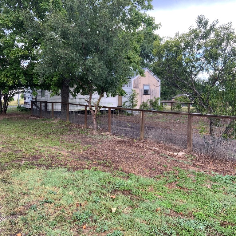 211 7th Street Jarrell, TX 76537 - Photo 6 of 26 a backyard of a house with table and chairs