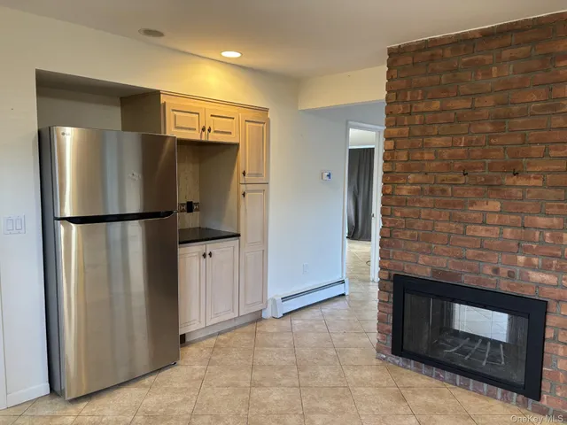 a kitchen with stainless steel appliances granite countertop a refrigerator and a stove