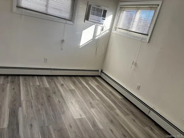a view of a room with wooden floor and windows