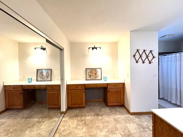a view of a kitchen with wooden floor and electronic appliances