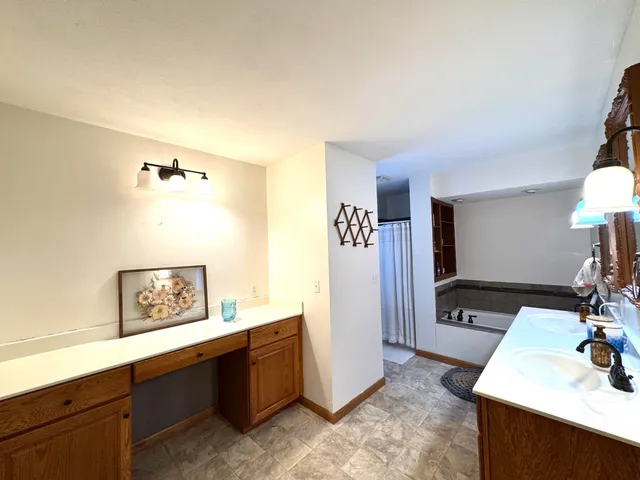 a view of a hallway with workspace and mirror