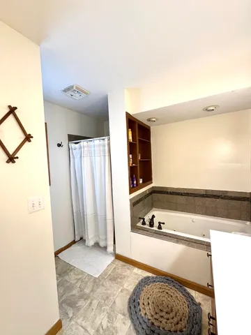 a bathroom with a tub and shower
