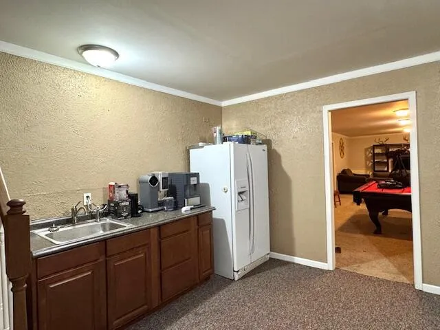 a kitchen with refrigerator and car