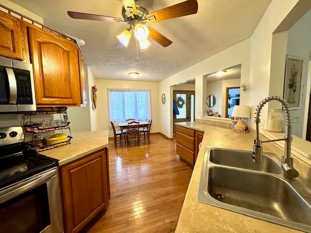 a kitchen with a sink appliances and cabinets