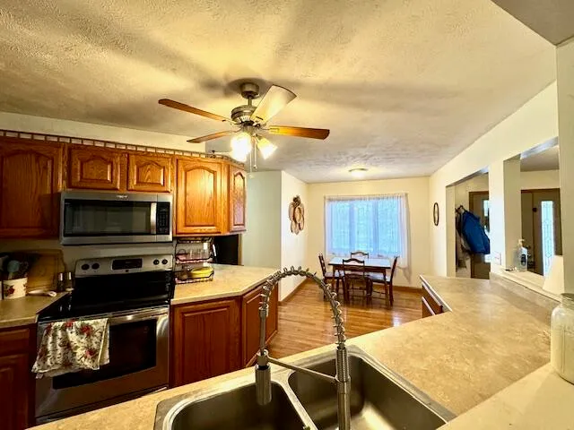 a kitchen with a stove a sink and a microwave