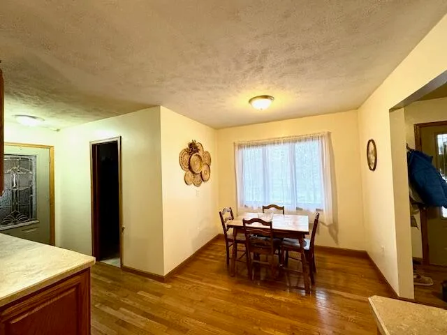 a view of a dining room with furniture and a window