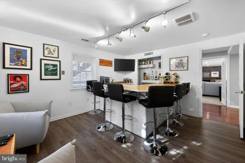 a living room with furniture a wooden floor and a chandelier