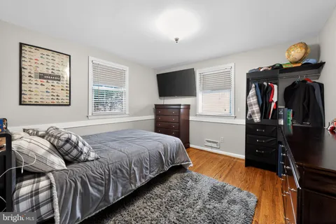 a bedroom with a bed and a television