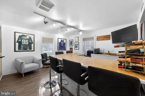 a dining room with furniture and a flat screen tv