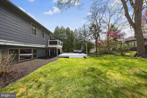a view of a house with swimming pool and sitting area