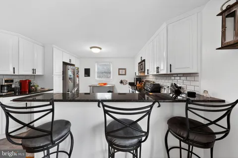 a kitchen with a dining table and chairs