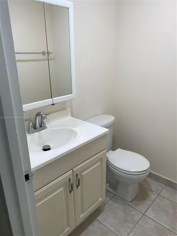 a bathroom with a sink mirror and toilet